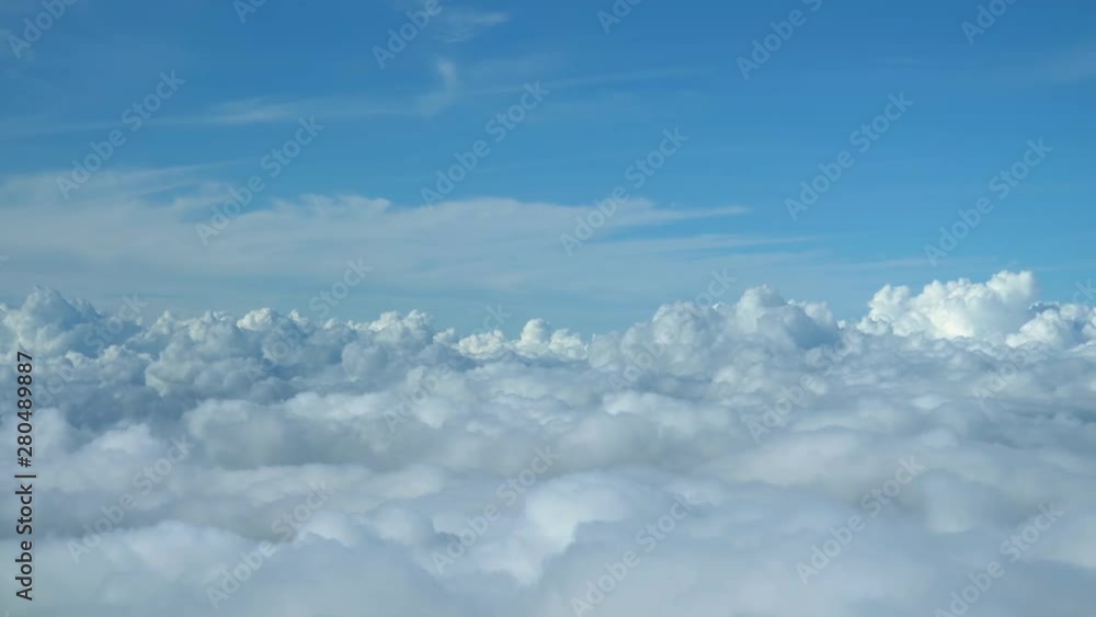 Airplane flying over the clouds view from cockpit Airplane flying over the clouds view from cockpit
