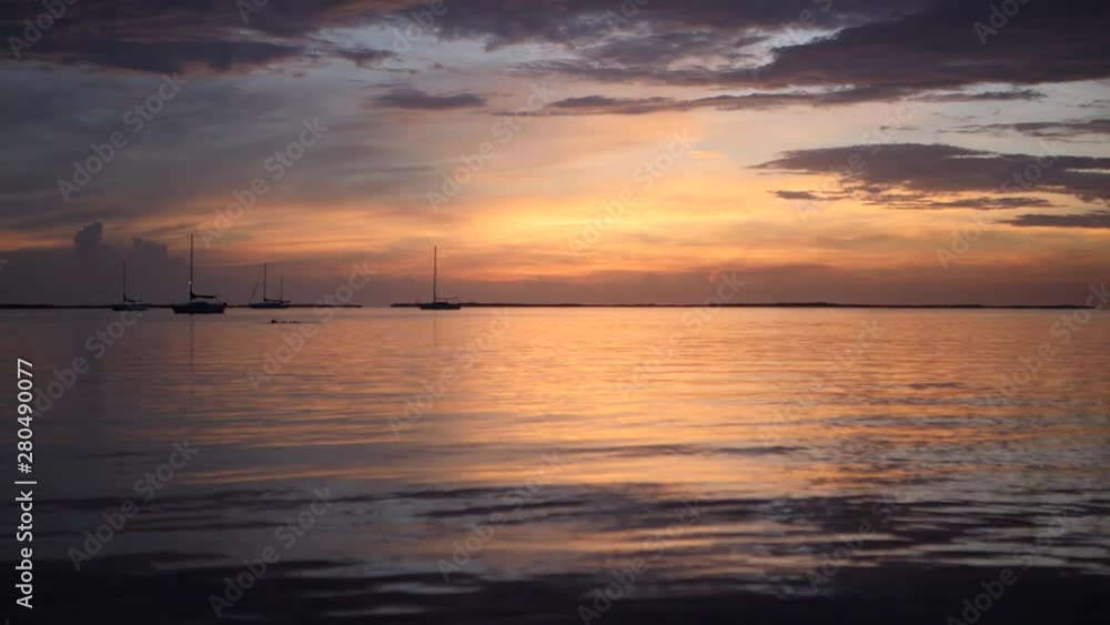 Smooth dock waters of Key West Florida at sunset golden hour, wide shot Smooth dock waters of Key West Florida at sunset golden hour, wide shot