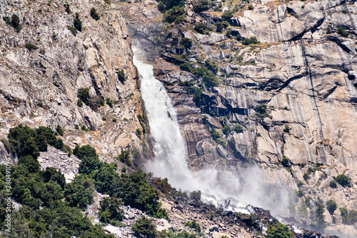 Fototapeta Naklejka Na Ścianę i Meble -  View towards Wapama falls dropping along granite walls; Hetch Hetchy Reservoir area, Yosemite National Park, Sierra Nevada mountains, California