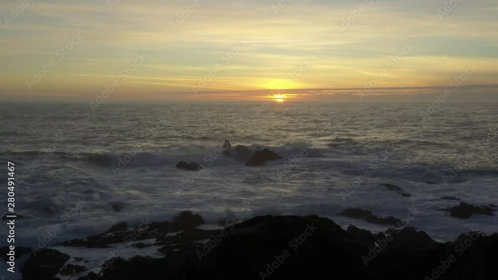 Aerial flying over ocean at sunset in Big Sur California Aerial flying over ocean at sunset in Big Sur California