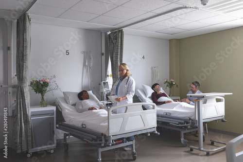 Doctors interacting with patients in the ward photo