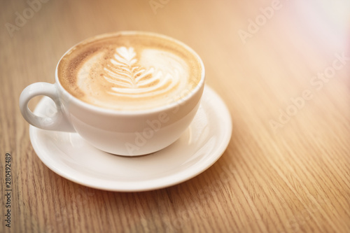 Hot coffee cappuccino latte art on wooden background