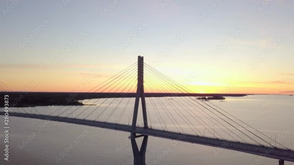 Aerial, rising, drone shot, tilting towards the Replot bridge, the longest bridge in Finland, at sunset, in the Kvarken archipelago, on a sunny, summer evening, in Raippaluoto , Vaasa, Ostrobothnia Aerial, rising, drone shot, tilting towards the Replot bridge, the longest bridge in Finland, at sunset, in the Kvarken archipelago, on a sunny, summer evening, in Raippaluoto , Vaasa, Ostrobothnia