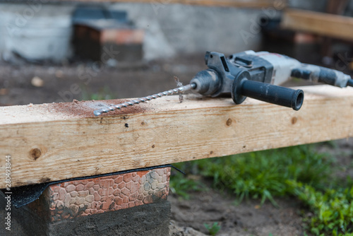 drill a hole in the board. Drill a hole in the timber. photo