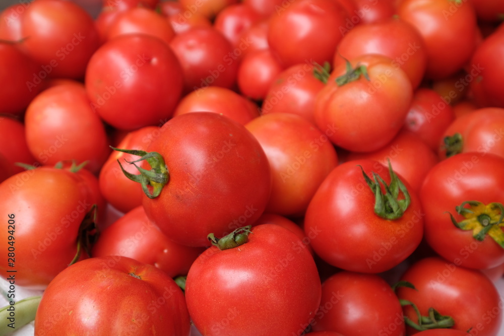Close up heap of fresh red tomatoes under natural daylight Close up heap of fresh red tomatoes under natural daylight