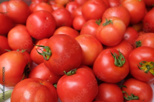 Close up heap of fresh red tomatoes under natural daylight