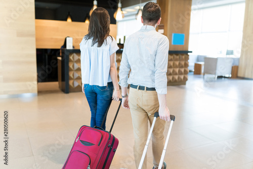 Newlywed Man And Woman Moving Out From Hotel photo