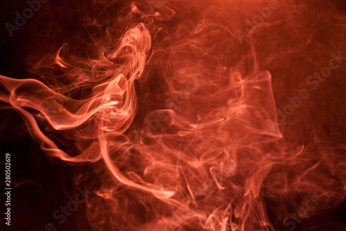 Red smoke on a black background.