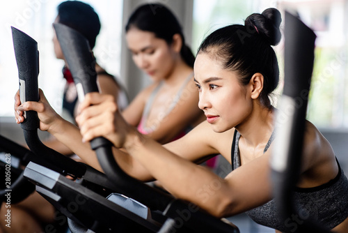 Young healthy woman bike cardio at the gym