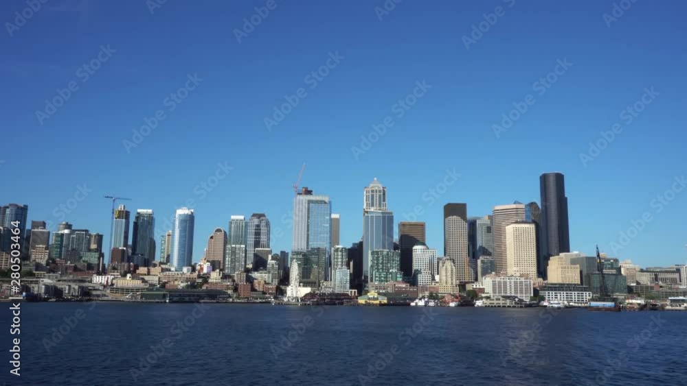 Downtown Seattle as seen from ferry boat traveling across the Puget Sound on a clear Summer day. Downtown Seattle as seen from ferry boat traveling across the Puget Sound on a clear Summer day.