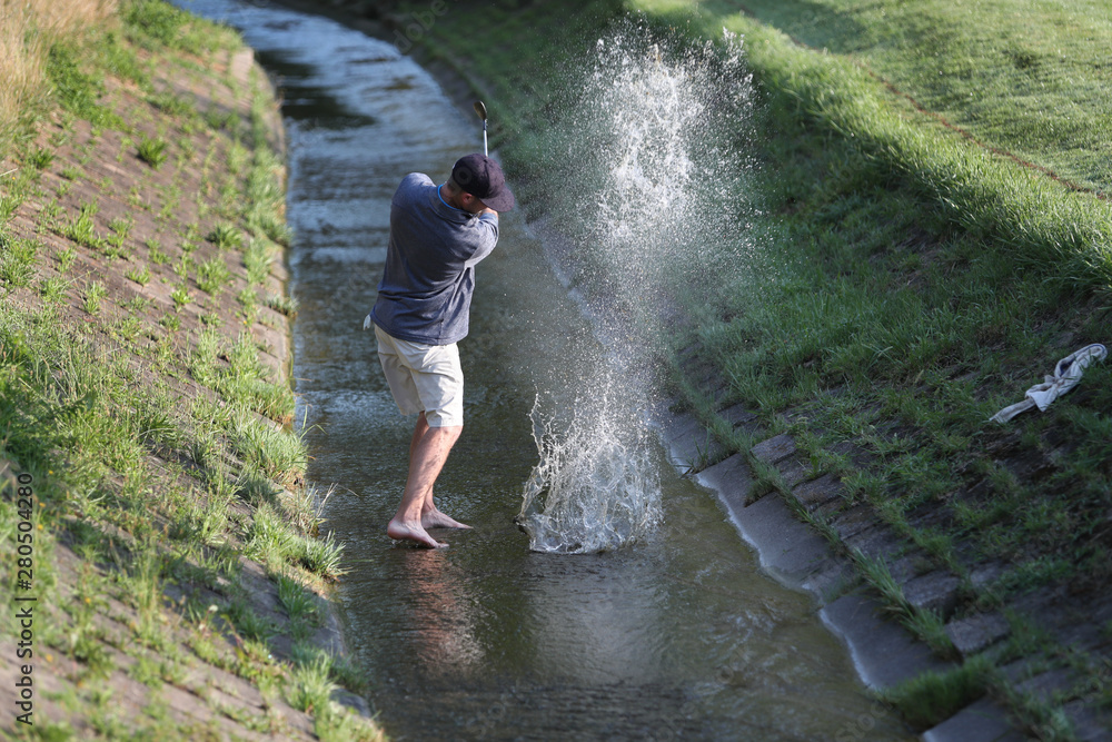 A tournament golfer, after hitting his tee shot into a creek, hits it out of a creek, to avoid a penalty stroke
