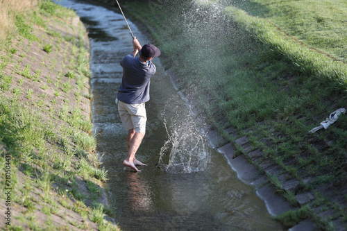 A tournament golfer, after hitting his tee shot into a creek, hits it out of a creek, to avoid a penalty stroke