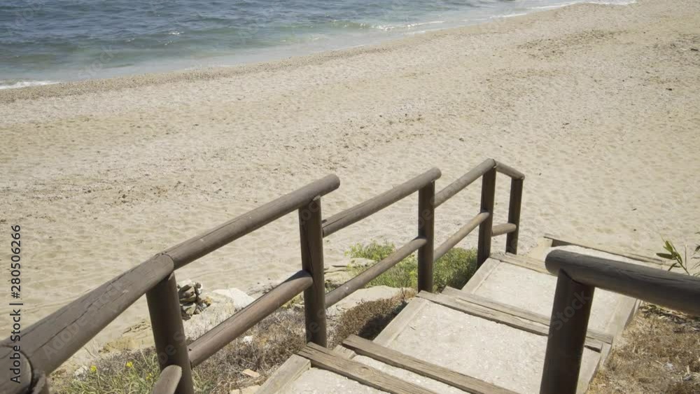 Coming down the steps and onto the sand at the lovely beach of Cala de Mijas on the Costa Del Sol in Southern Spain. Coming down the steps and onto the sand at the lovely beach of Cala de Mijas on the Costa Del Sol in Southern Spain.