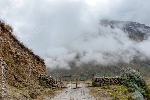 Curved mountain road in misty mountains, Abra Mariano Llamoja, pass between Yanama and Totora, The Choquequirao trek, Peru photo