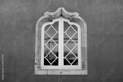 Old Victorian Window with Diagonal Muntin's and Ornate Curved Stone Frame
