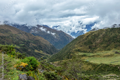 Green valley surrounded by mountains in clouds  Choquequirao trek between Yanama and Totora  Peru