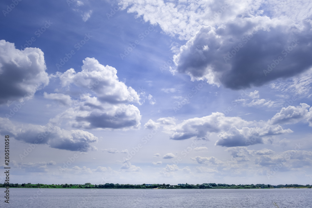 Minimalist landscape of small patch of water under vast beautiful sky with clouds