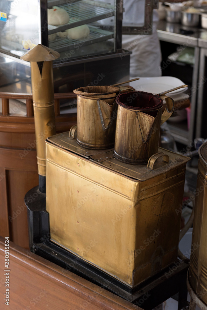 Fototapeta premium Vintage thai coffee boiler pot with hot vapor in coffee shop
