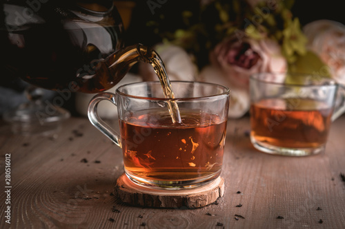 Fototapeta Naklejka Na Ścianę i Meble -  Pouring tea into cup of tea
