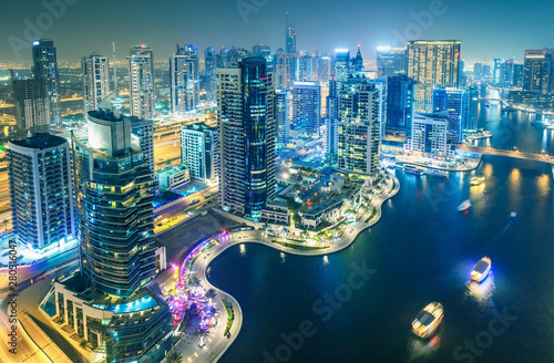 Scenic nighttime skyline of big modern city. Aerial view of Dubai Marina, UAE.