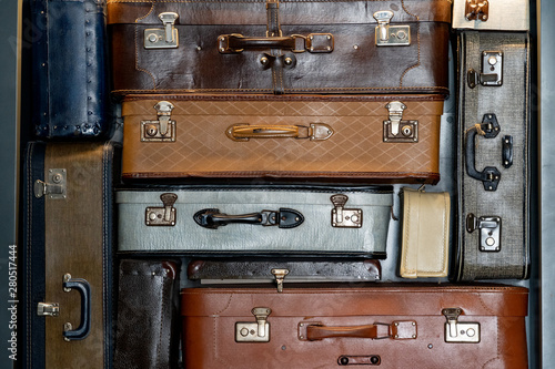 Stack of vintage leather suitcases background