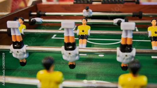 Table football, table football with close-ups of yellow and white players.
