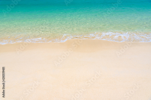 Fantastic golden sand beach with clear blue water. Summer outdoor nature holiday serenity. Beautiful clean sandy beach with soft blue ocean wave. Background, copy space or space for text.