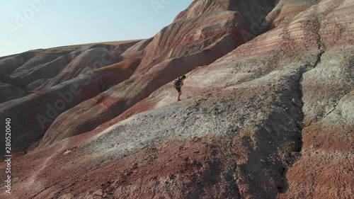 Backpacker girl exploring the mountains. Backpacker girl tourist exploring the Xizi mountains , Azerbaijan. Aerial video 4k