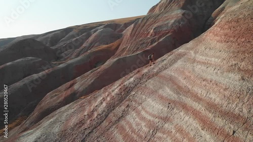Backpacker girl exploring the mountains. Backpacker girl tourist exploring the Xizi mountains , Azerbaijan. Aerial video 4k