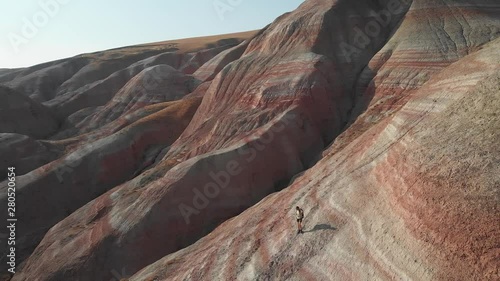 Backpacker girl exploring the mountains. Backpacker girl tourist exploring the Xizi mountains , Azerbaijan. Aerial video 4k