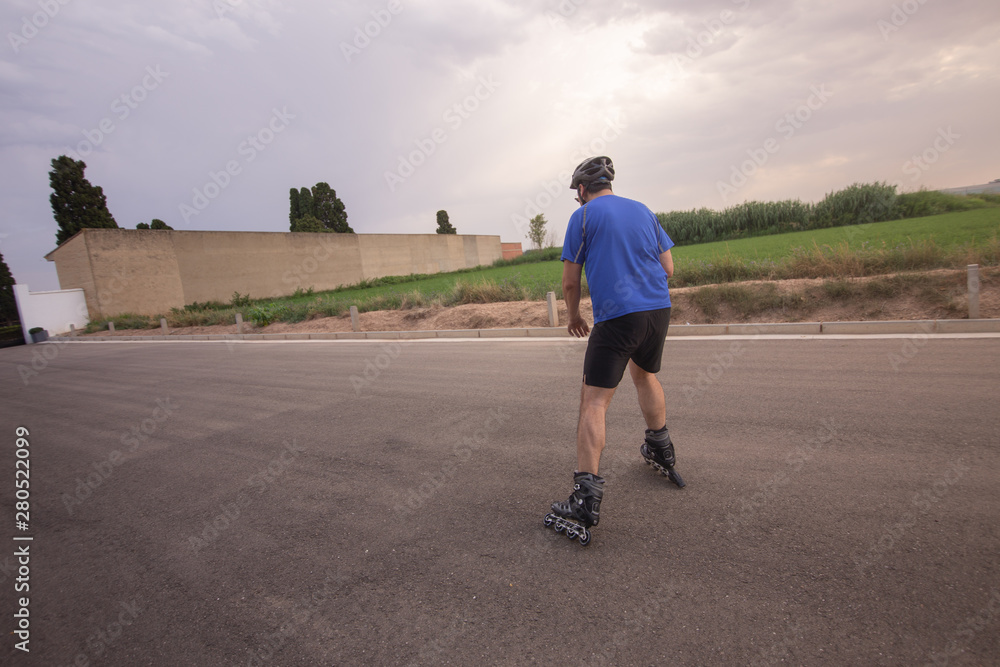 man with inline skates skating on the street