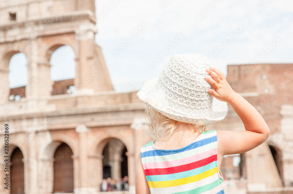Little girl enjoying the view of the coliseum  in Rome, Italy. Back view