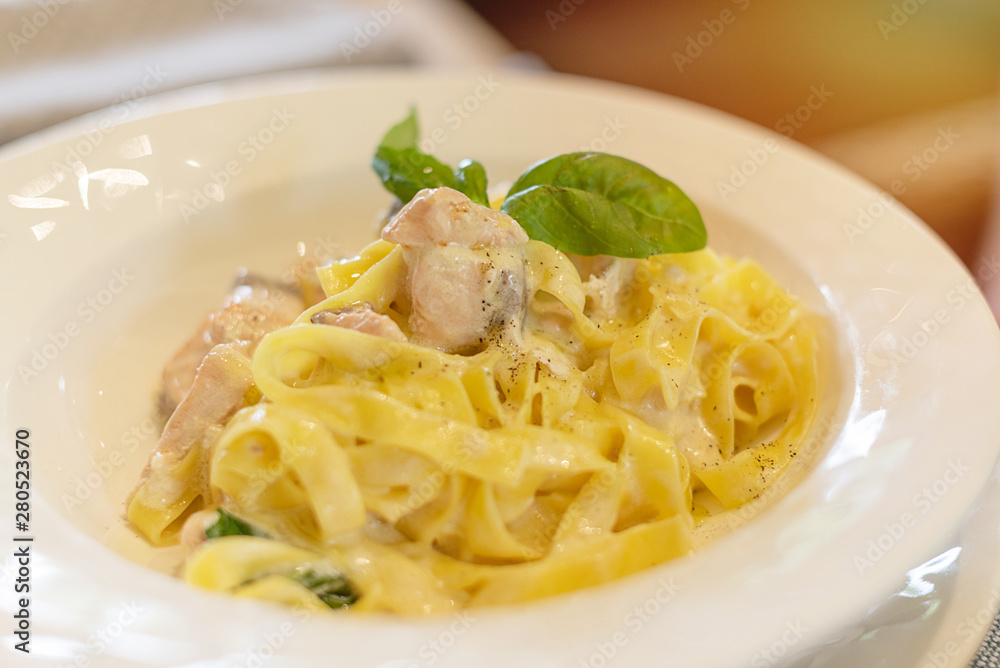 pasta with salmon on a white plate