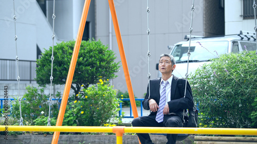 ブランコに乗る中高年男性 Stock Photo Adobe Stock