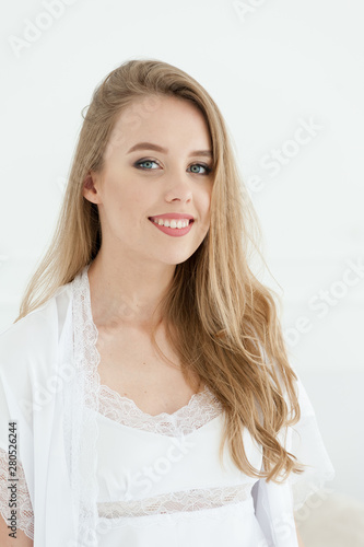 Beautiful happy young woman white underwear. Morning bride.