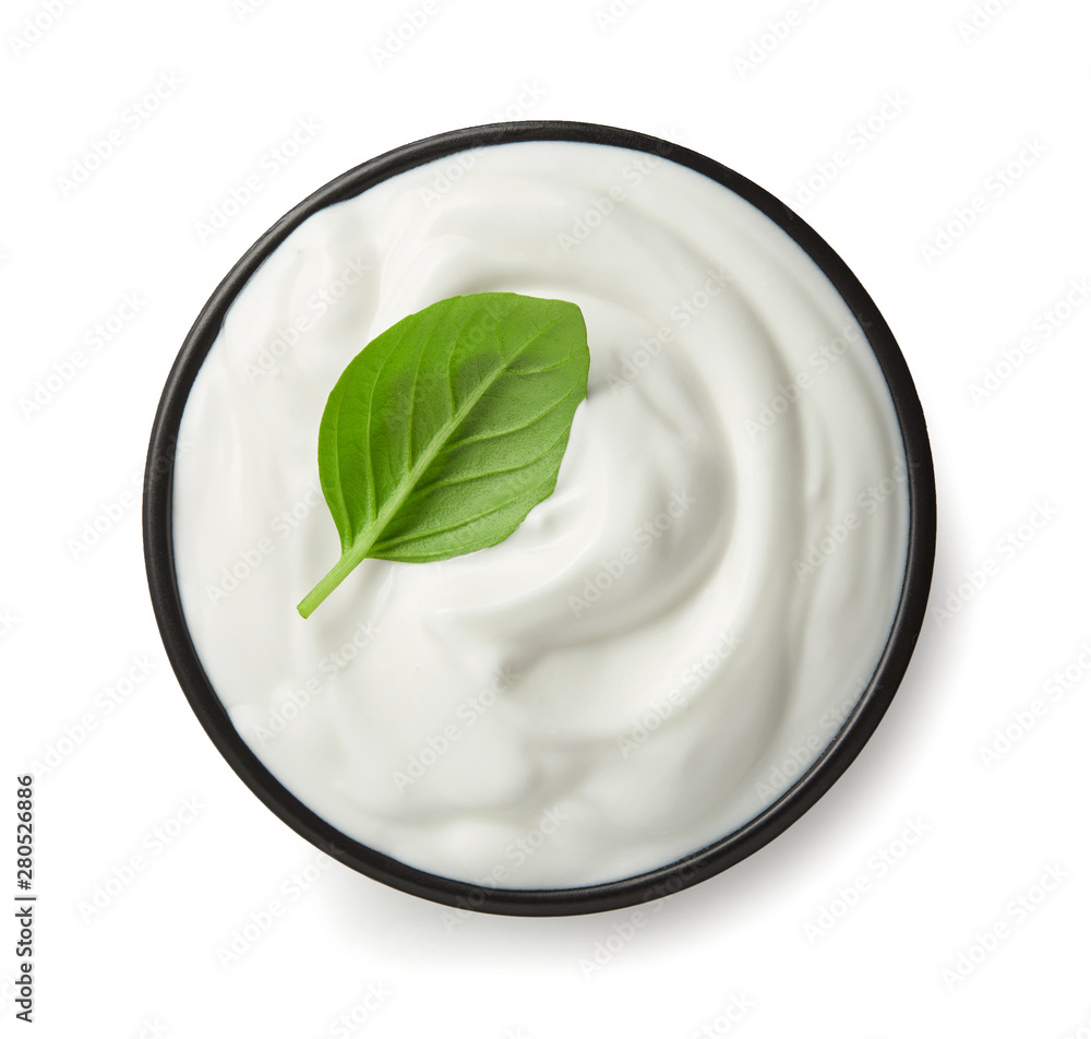 Sour cream or yoghurt is black bowl top view isolated on white background Sour cream or yoghurt is black bowl top view isolated on white background
