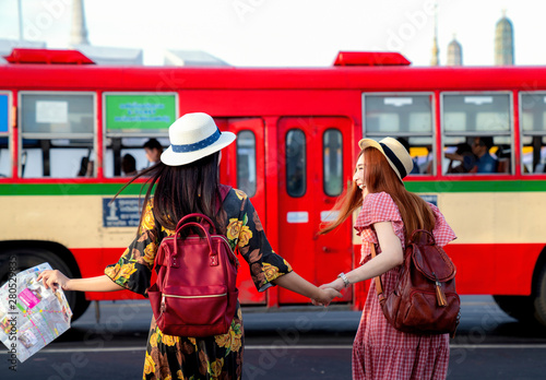 Canvas Print Two asian girlfriends traveling and transportation by bus