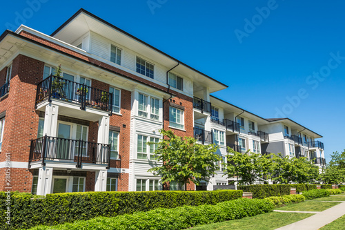 Luxury apartment building with green lawn in front