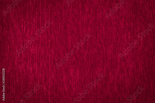 Abstract texture of a rough dark burgundy paper background and copy space for text. Macro fiber paper.