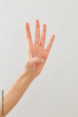 Young lady's hand gesture: four  on white © 1981 Rustic Studio