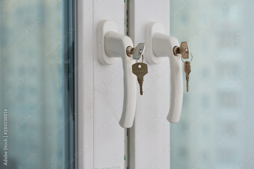 Protecting a child from falling out of windows. Handle with a lock on the window Protecting a child from falling out of windows. Handle with a lock on the window