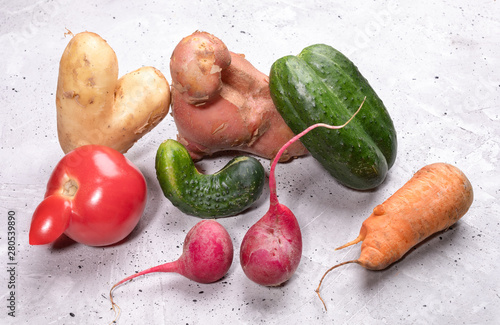 Obraz na plátně Pile of ripe ugly vegetables on concrete background.