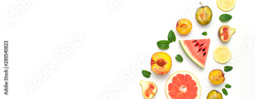 Tropical Summer Fruit Concept. Creative layout made of fresh ripe watermelon, peach, plum, fig, lemon, grapefruit and mint leaves on white background. Flat lay, top view, copy space. Food background