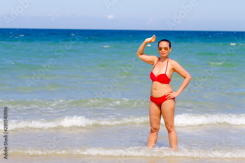 Woman and red bikini shape large on beach at Ban Krut