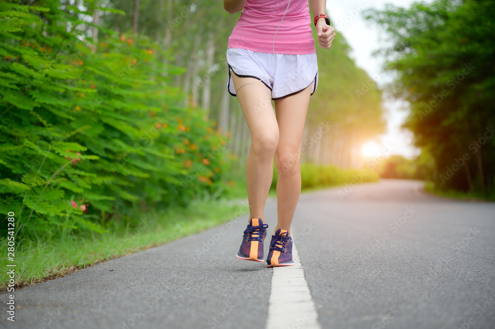 legs of healthy woman jogging alone at daily morning in public park, daily exercise workout running of woman