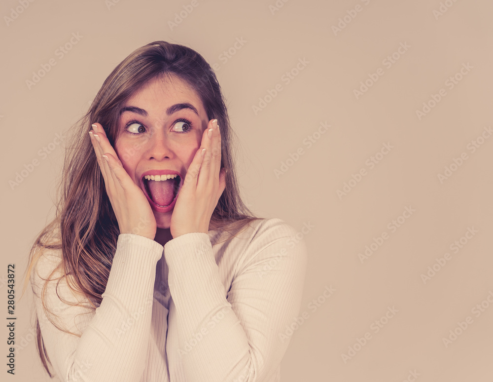 Happy young attractive teenager girl shocked with surprised funny face. Human expressions Happy young attractive teenager girl shocked with surprised funny face. Human expressions