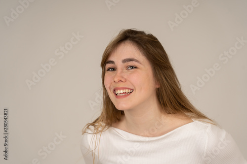 Portrait of young attractive cheerful teenager woman with smiling happy face. Human expressions