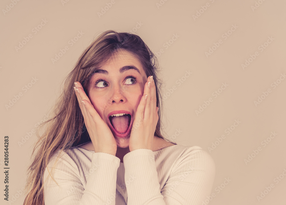 Happy young attractive teenager girl shocked with surprised funny face. Human expressions Happy young attractive teenager girl shocked with surprised funny face. Human expressions