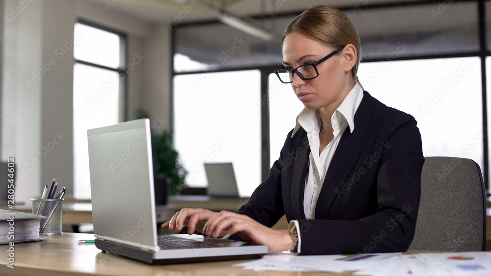 Serious business woman typing on laptop, working on complicated project, job Serious business woman typing on laptop, working on complicated project, job
