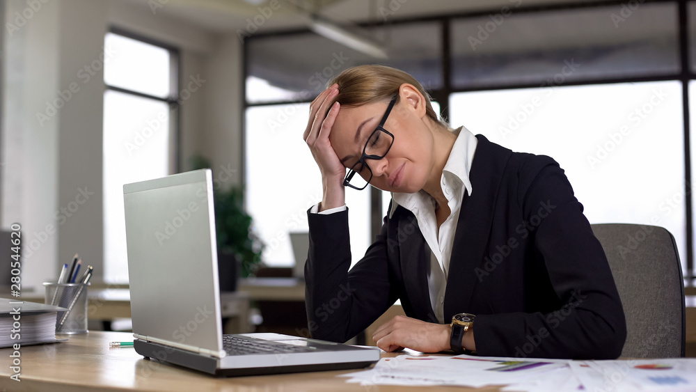 Disappointed woman forgot about business meeting, feeling strong headache Disappointed woman forgot about business meeting, feeling strong headache